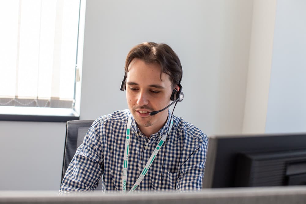 Man with headset providing customer support