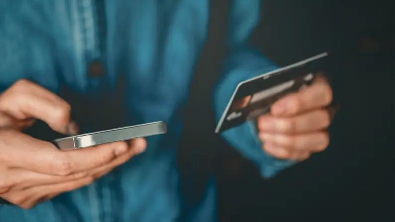 fintech man holding card and mobile