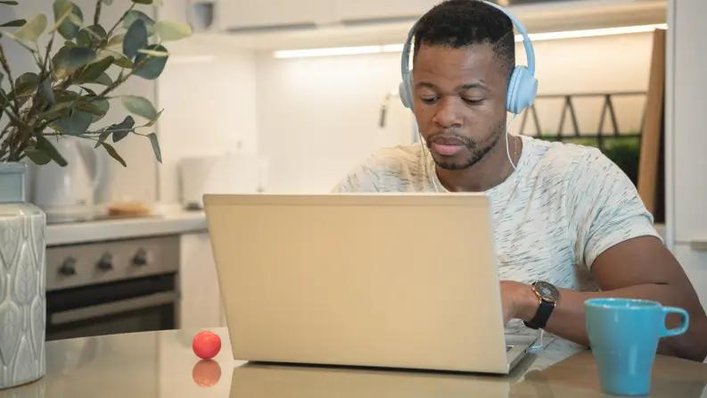 Boy with headset using laptop