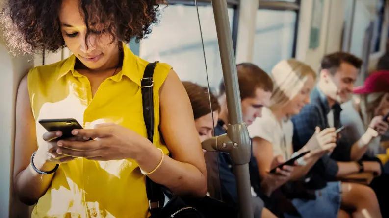 Woman using mobile in bus