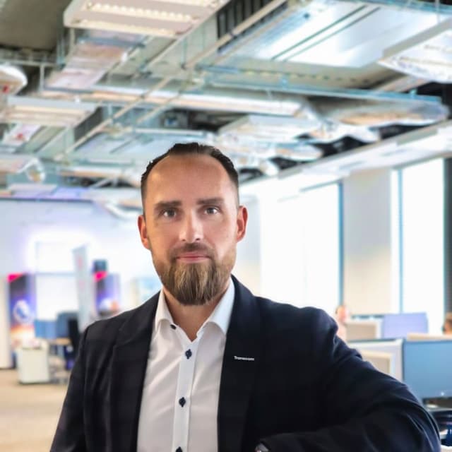 Headshot of a man in a suit in a modern office