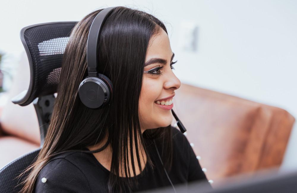 Smiling woman with headset in call center